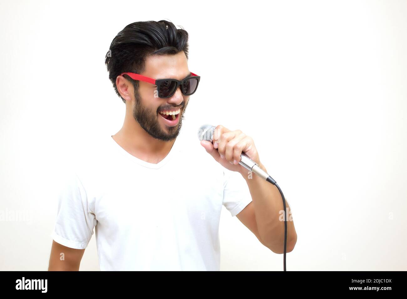 Young Man Wearing Sunglasses Singing Against White Background Stock