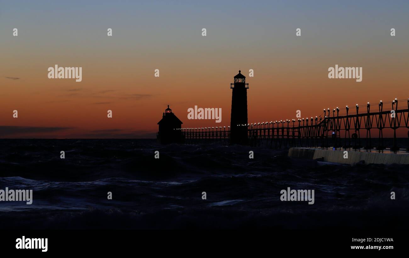 Grand Haven South Pier Lighthouse at sunset on Lake Michigan, on a windy day Stock Photo