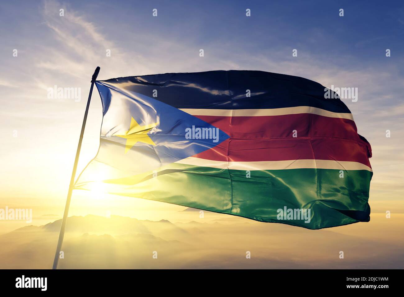 South Sudan flag waving on the top sunrise mist fog Stock Photo - Alamy
