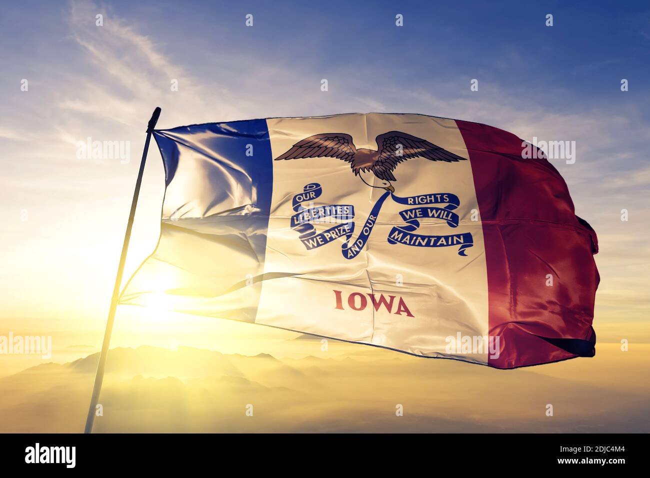 Iowa state of United States flag waving on the top sunrise mist fog