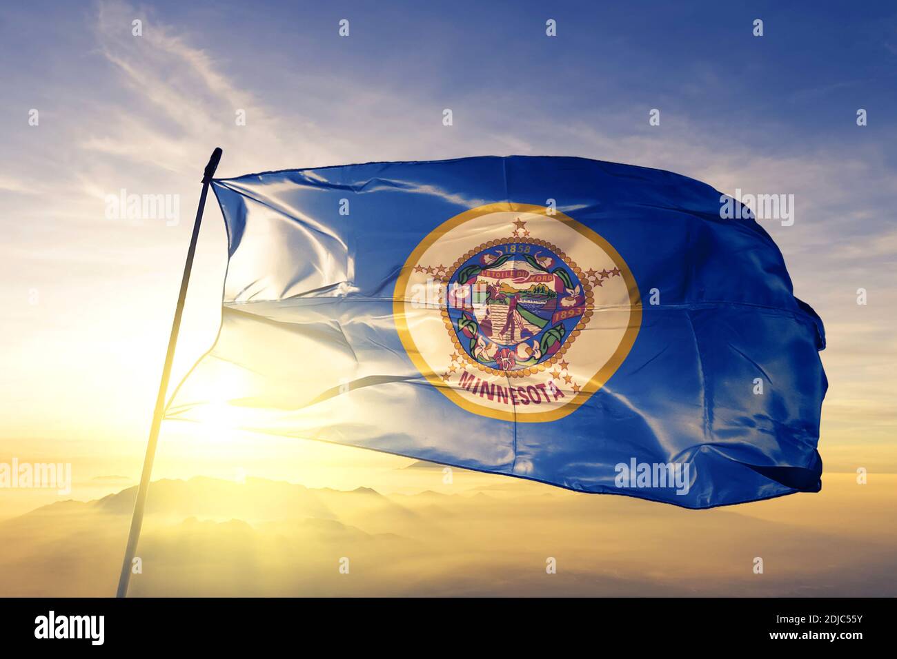 Minnesota state of United States flag waving on the top sunrise mist fog Stock Photo
