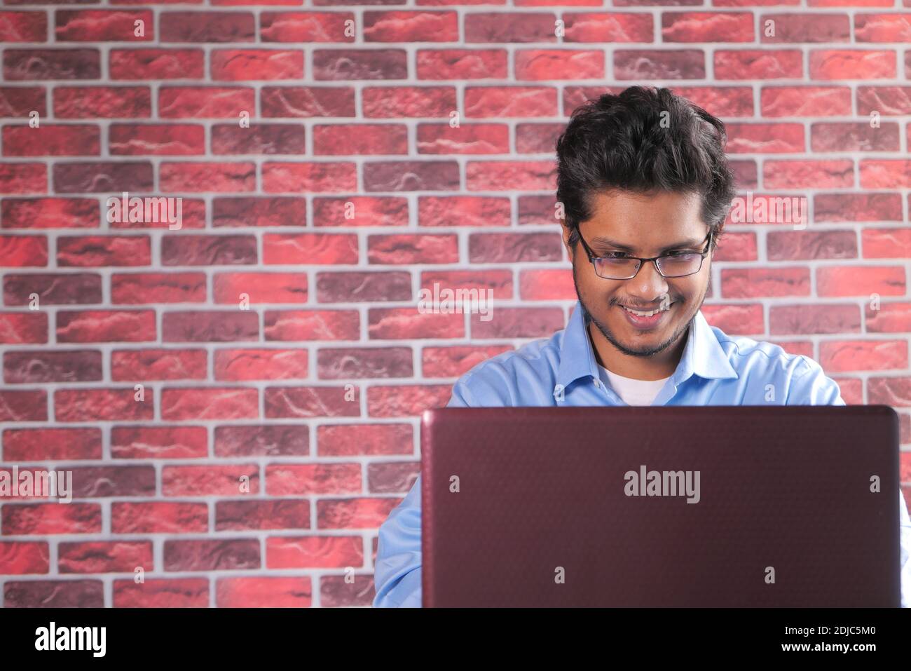 happy young asian man working on laptop with copy space  Stock Photo
