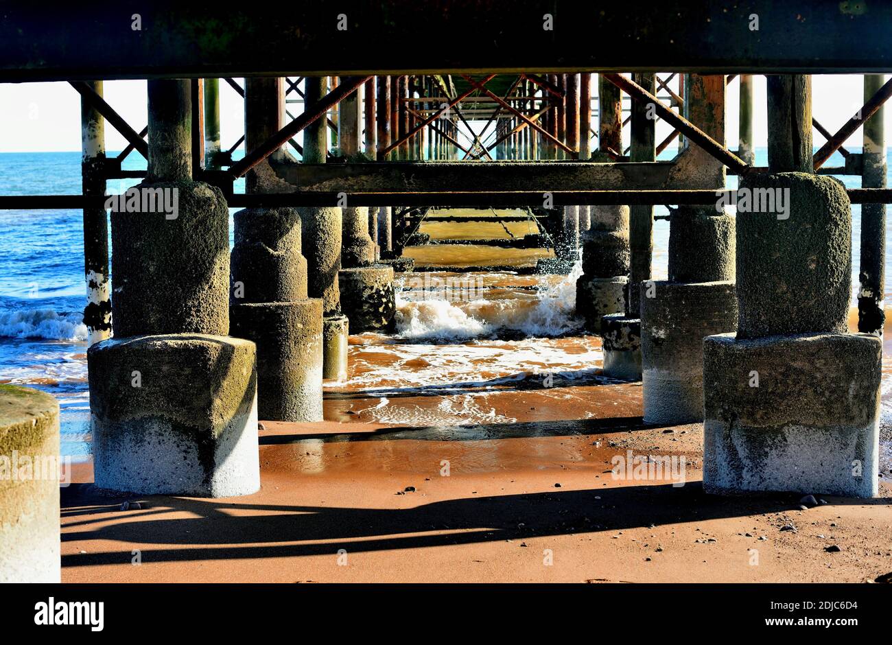 Incoming tide beneath the Grand Pier at Teignmouth. Stock Photo