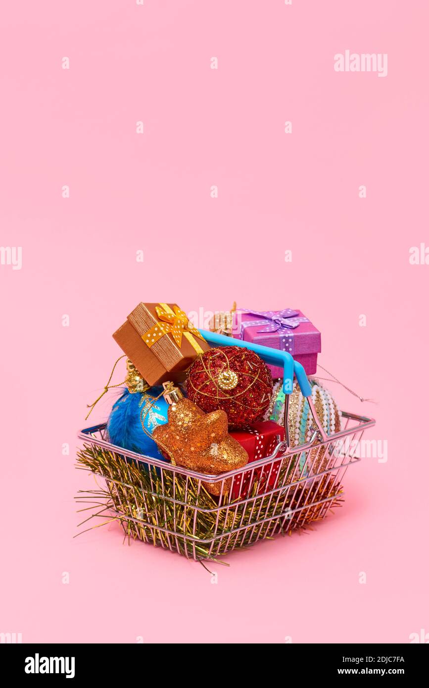 a metallic shopping basket full of different christmas ornaments and