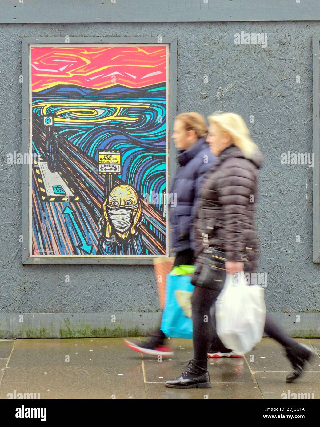Glasgow, Scotland, UK, 14th December, 2020: Not like Christmas in the city as dour weather and covid combine to lower the spirit and destroy the soul of the town. The new munsch street artwork tribute patronises social distancing and finds an audience amongst locals in the merchant city area.. Credit: Gerard Ferry/Alamy Live News Stock Photo