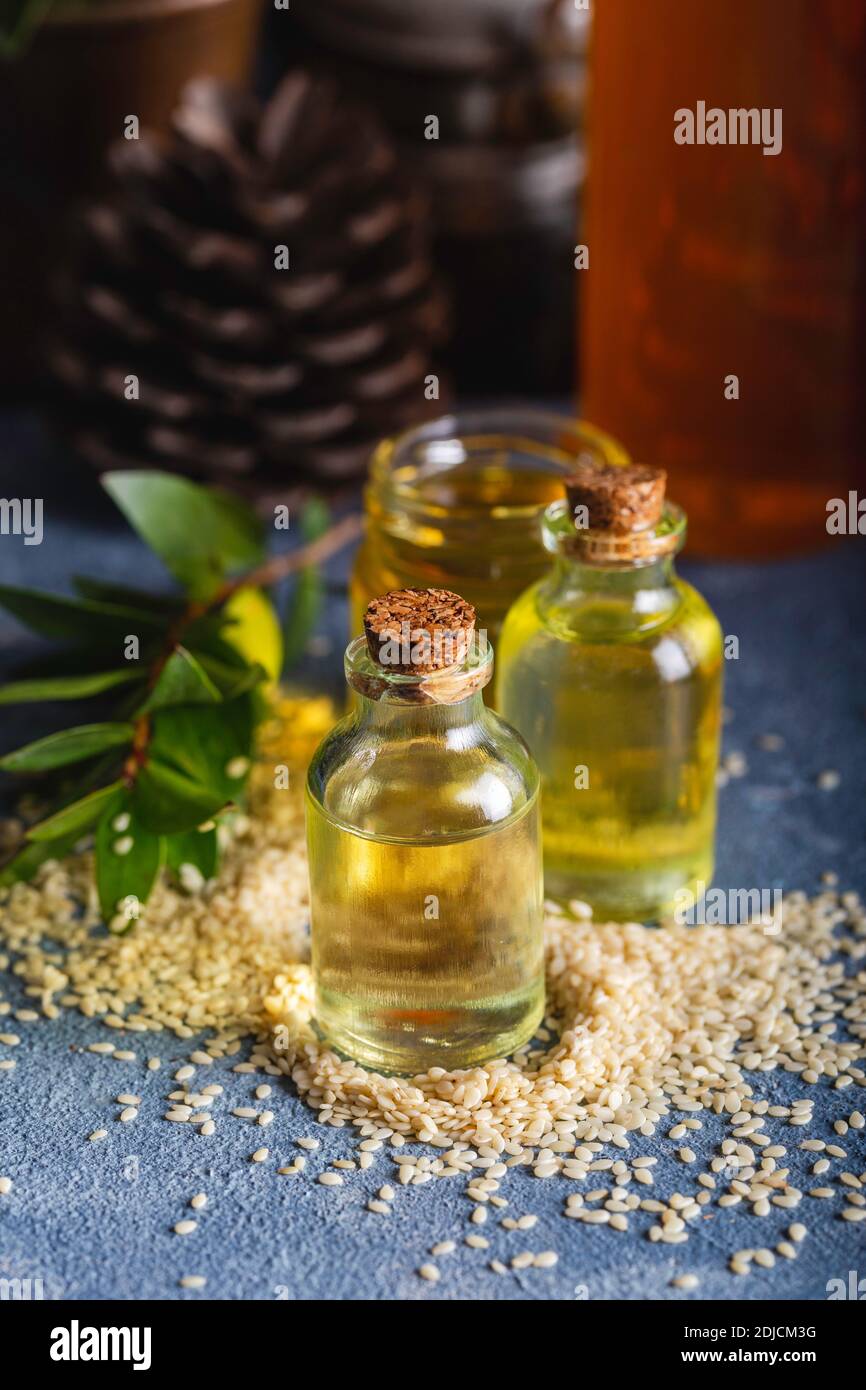 Sesame oil in glass and seeds. Fresh sesame oil in a glass bottle and