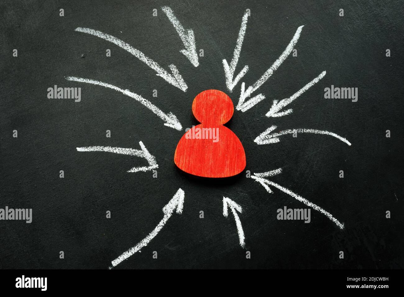 Resilience and assertiveness concept. Red figurine and arrows. Stock Photo