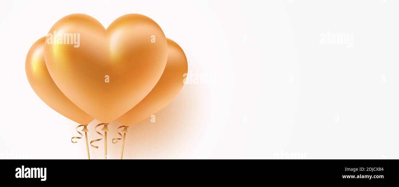 Heart shaped golden balloons, on the white background with copy space ...