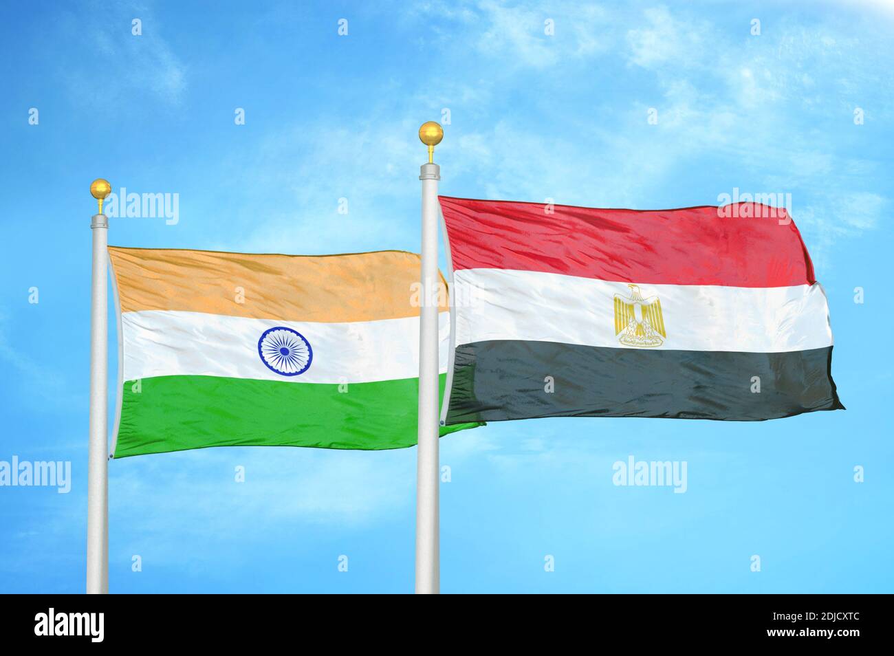 India and Egypt two flags on flagpoles and blue cloudy sky Stock Photo