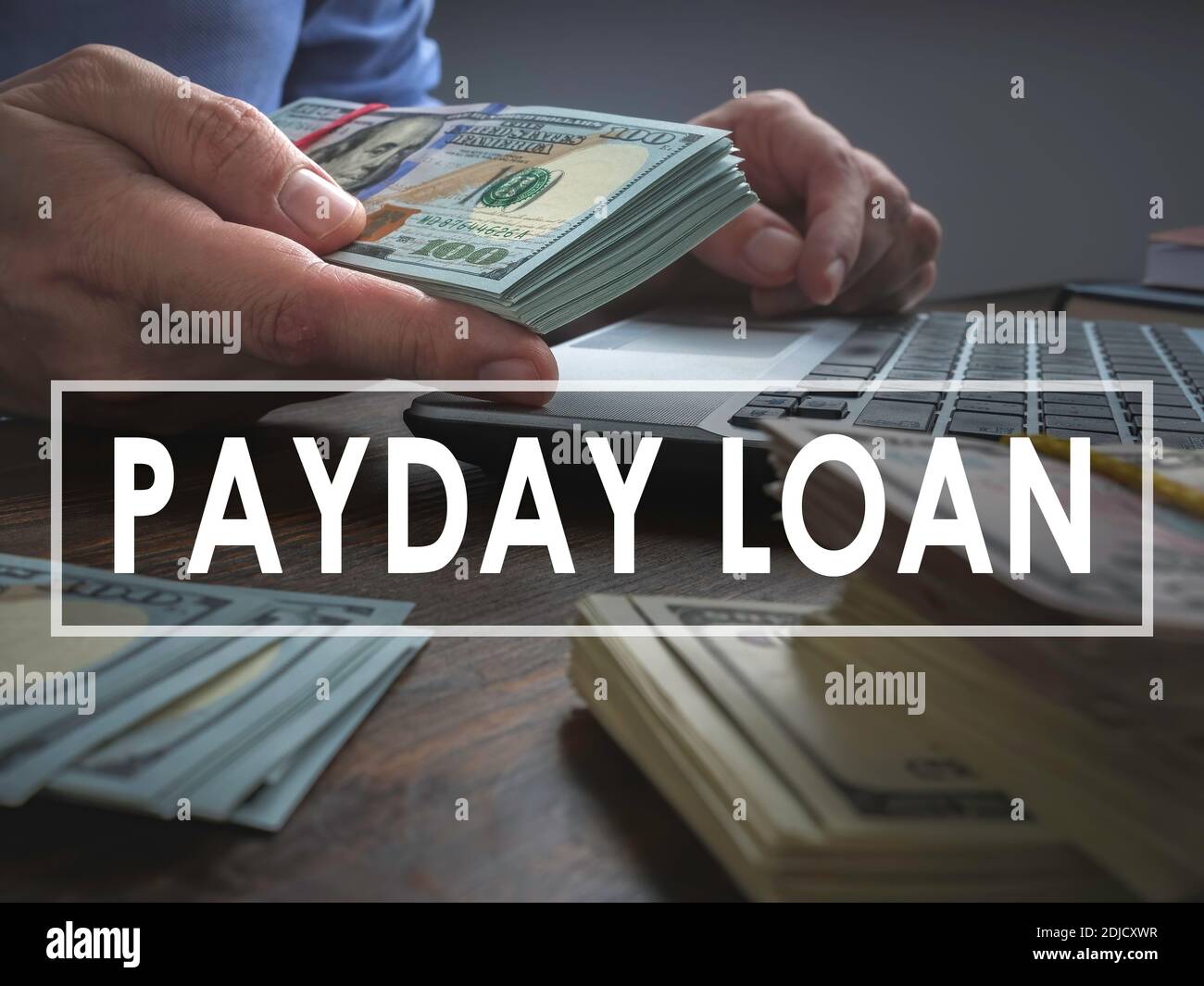 Payday loan concept. The man offers wad of cash. Stock Photo