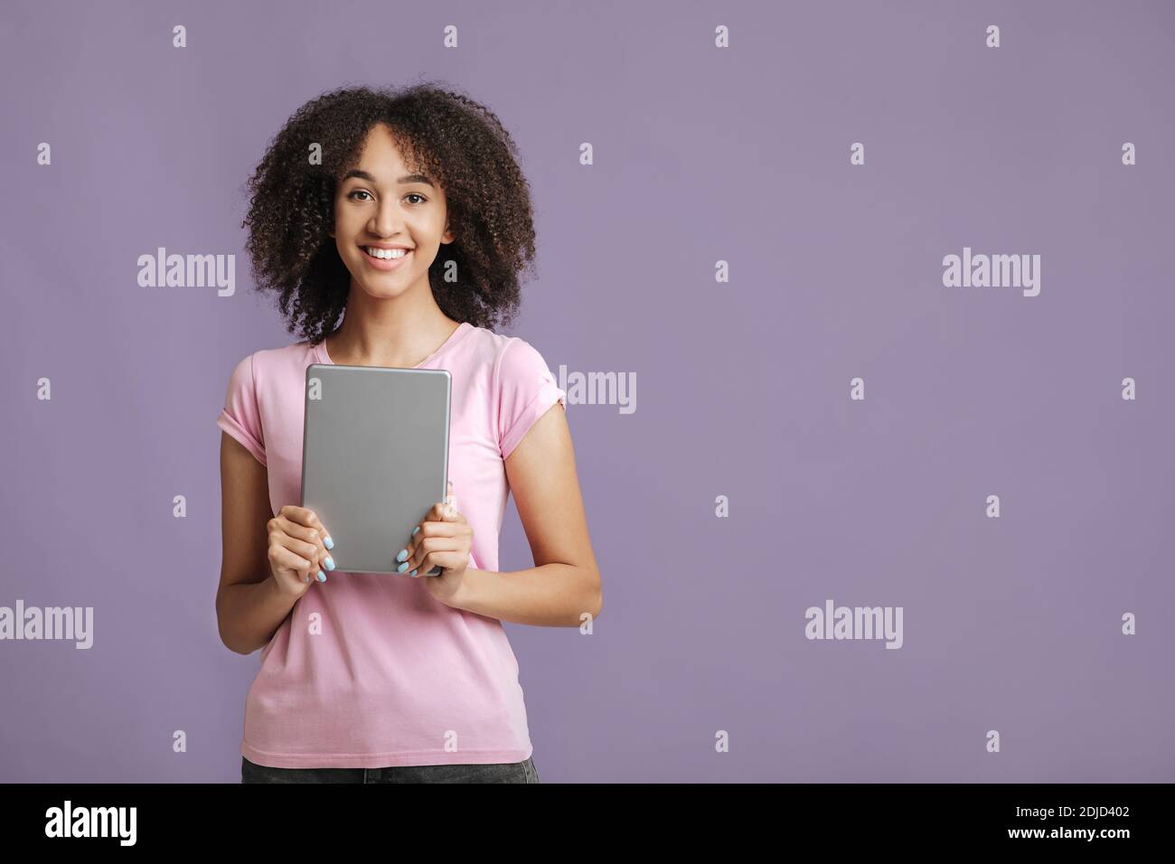 Positive expression and online win. Happy lady rejoices and holds digital tablet Stock Photo
