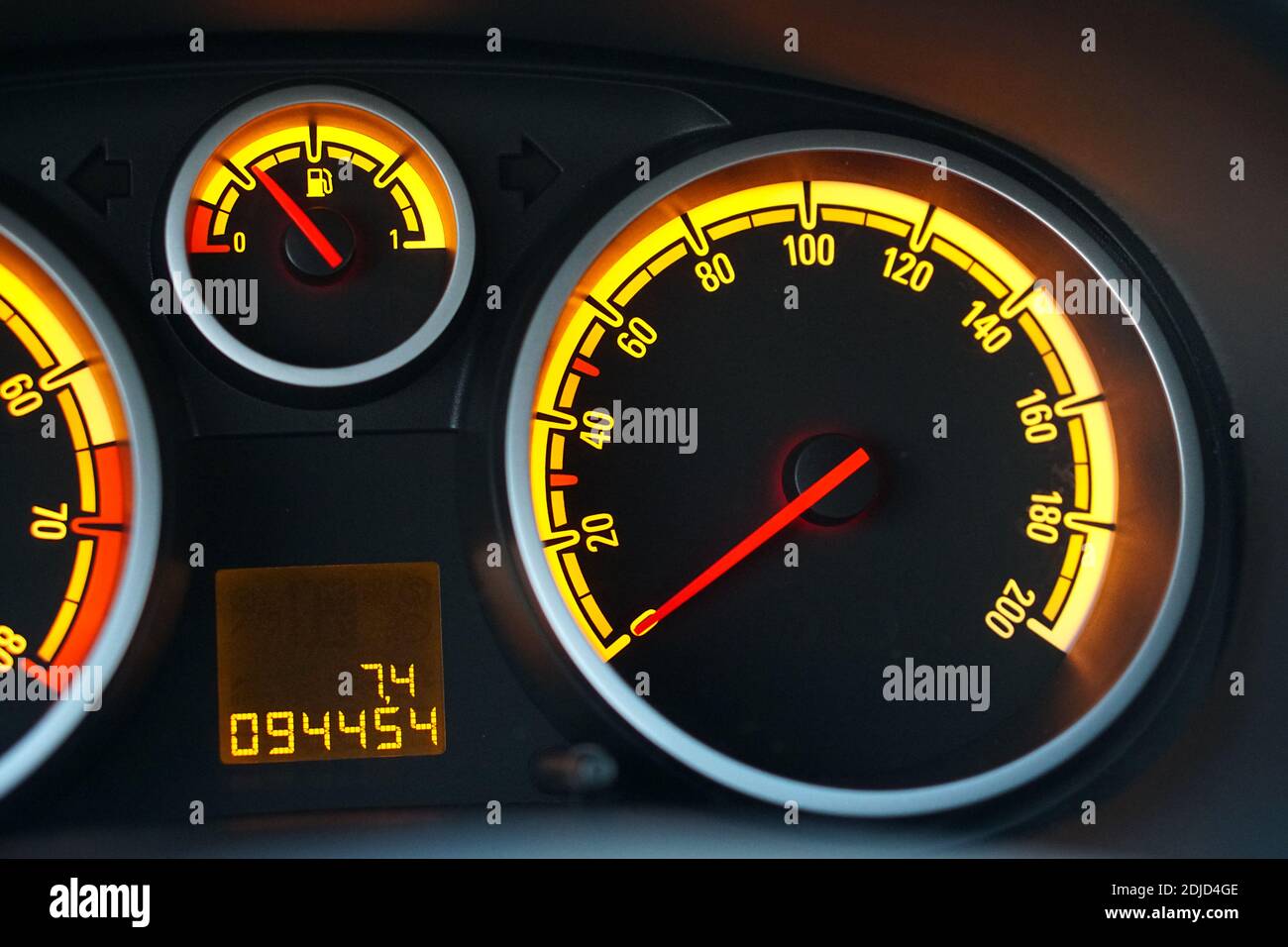 Analog car dashboard speedometer gauges with yellow lights Stock Photo