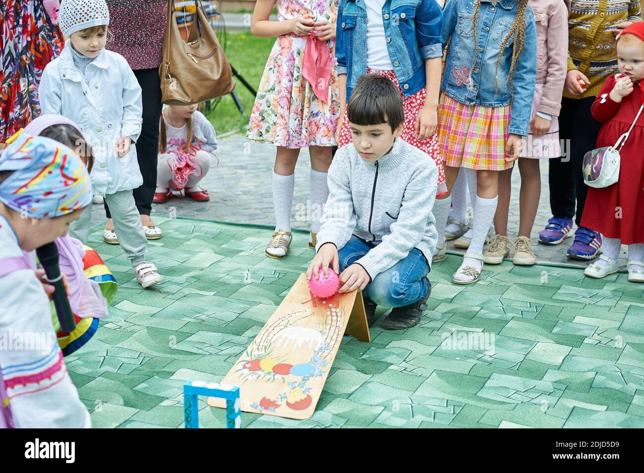 Astrakhan, Russia - 05.08.2016: Egg rolling, or an Easter egg roll is a traditional game played with eggs at Easter Stock Photo