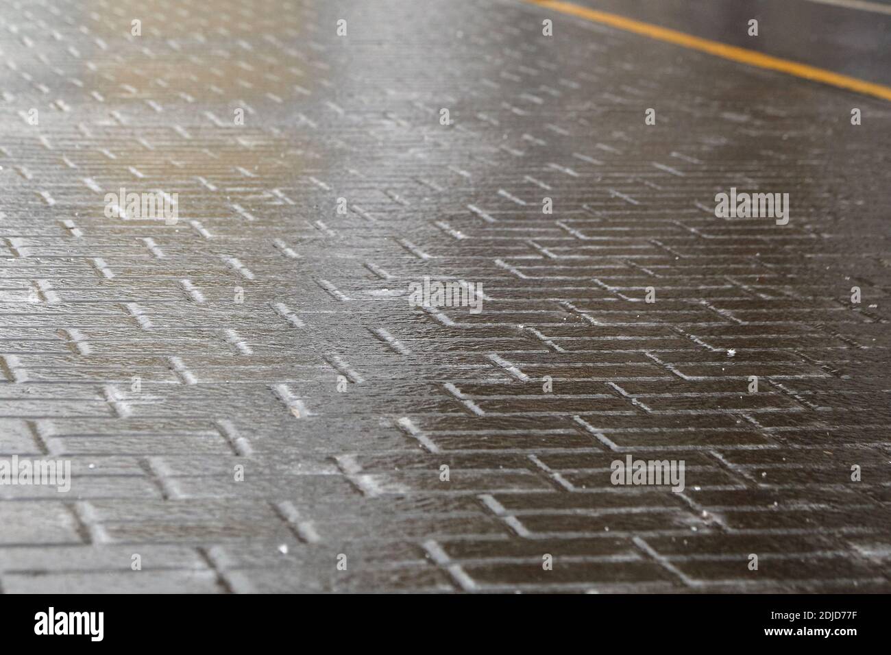 Ice crusted ground, paving slabs surface covered ice, slippery street