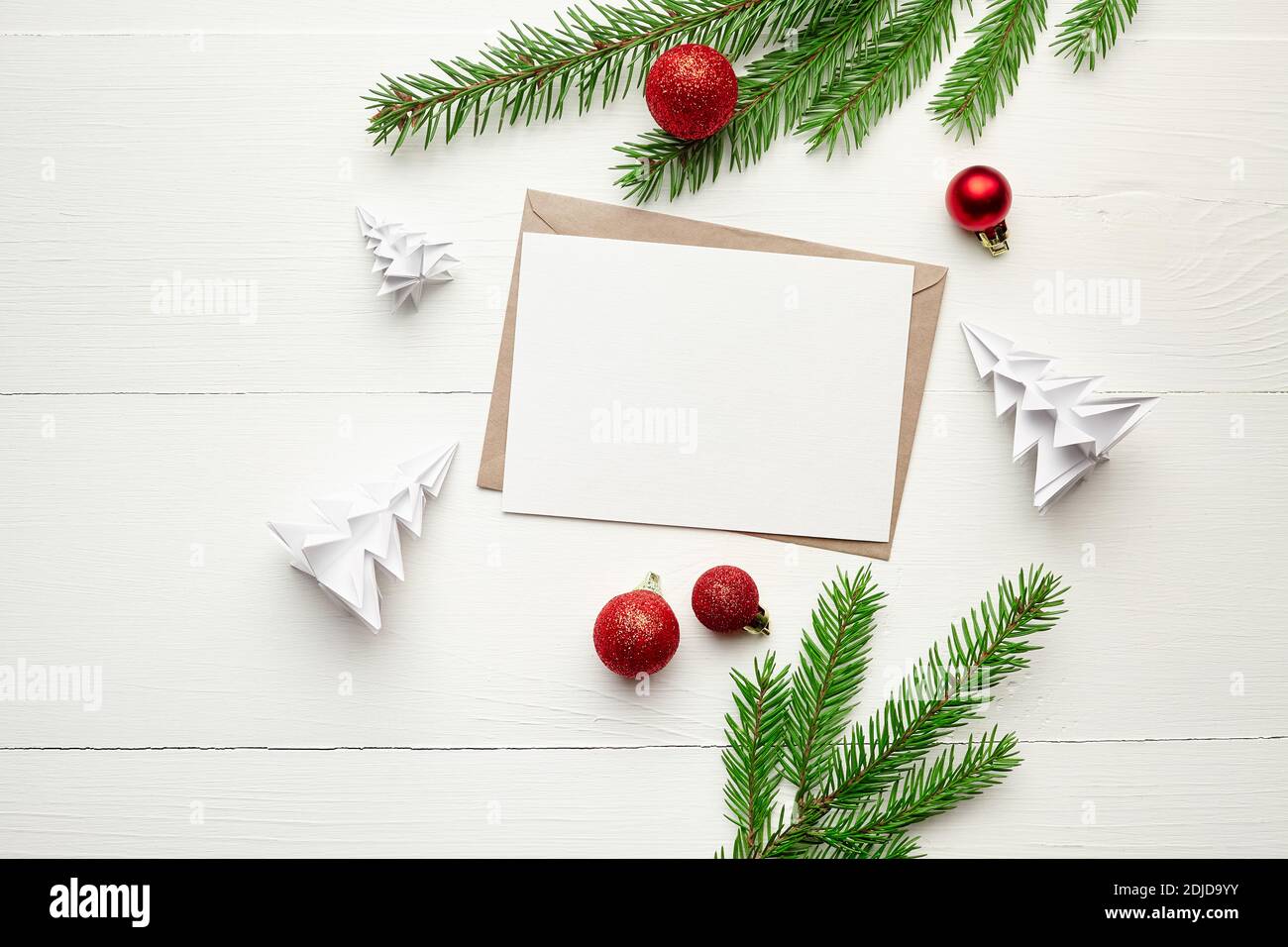 Greeting card mockup with christmas decorations and fir tree branches ...