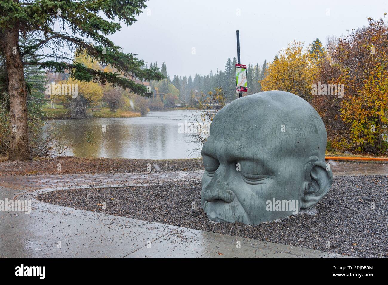 Big Head Sculpture. Town of Canmore Street view in Late fall to early winter season. Stock Photo
