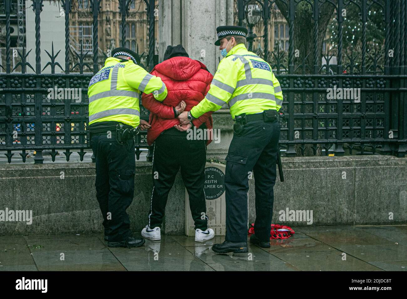 WESTMINSTER LONDON 14 December 2020. A protester is handcuffed by police  during an anti lockdown protest organised by StandUp X in Westminster.  London is to be moved to 'Tier 3' restrictions, high
