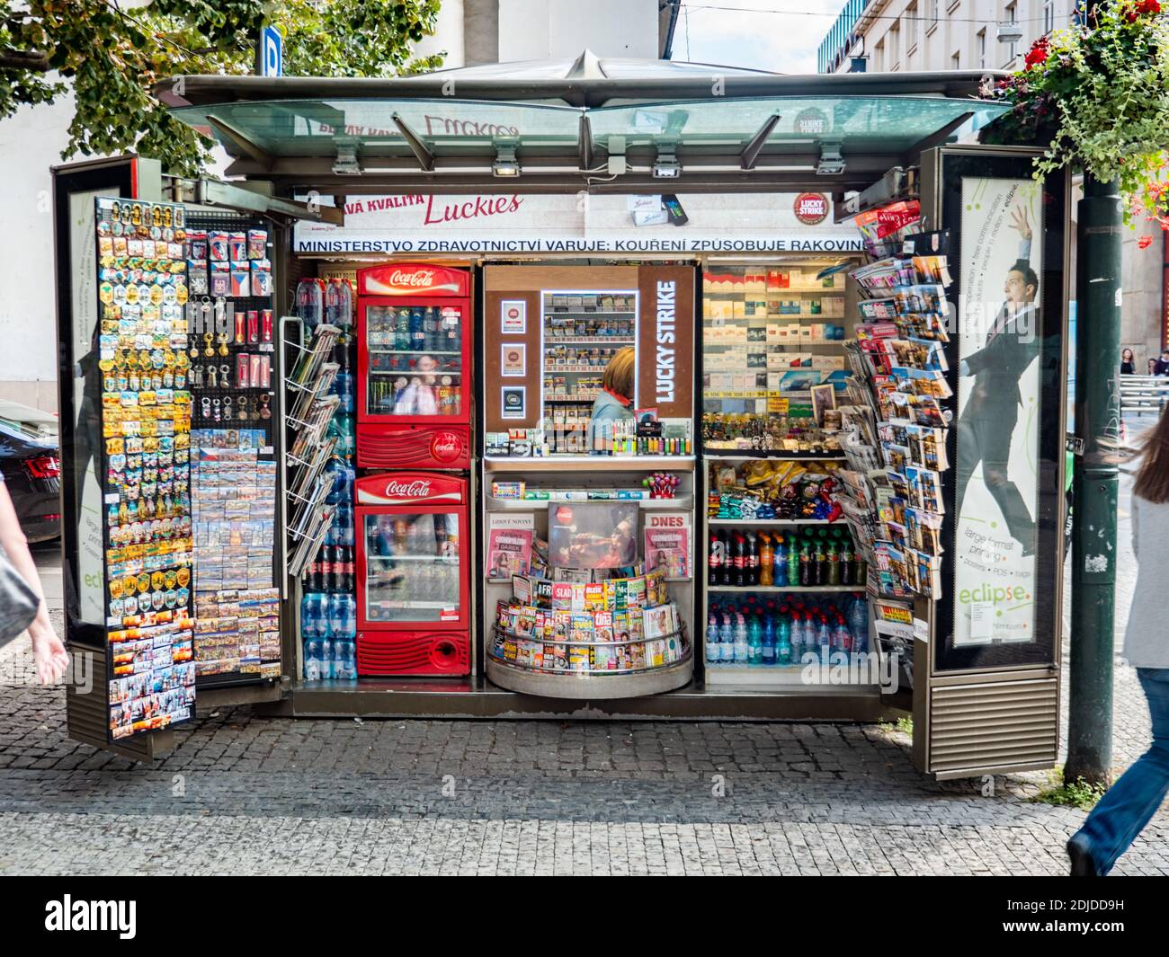 Pavement news vendor. A small kiosk on the cobbled streets of Prague selling newspapers, cigarettes, refreshments and souvenirs. Stock Photo