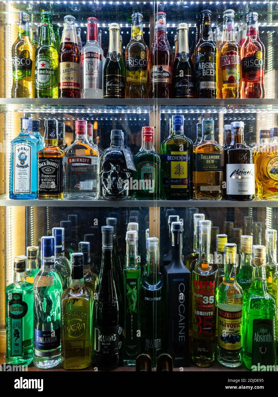 Spirit bottles on display. A shop window of an absinthe shop in central Prague with some unusual alcoholic drinks available. Stock Photo
