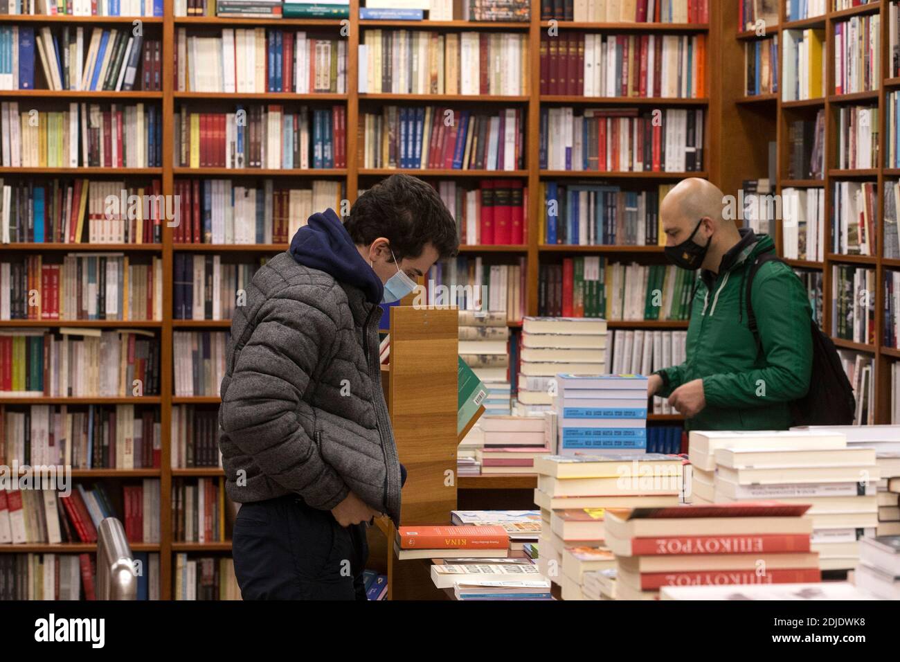 Athens, Greece. 14th Dec, 2020. People wearing face masks are seen in a bookshop in Athens, Greece, Dec. 14, 2020. Greece reported 693 new COVID-19 cases, bringing the national total to 124,534, authorities announced on Sunday. Credit: Marios Lolos/Xinhua/Alamy Live News Stock Photo