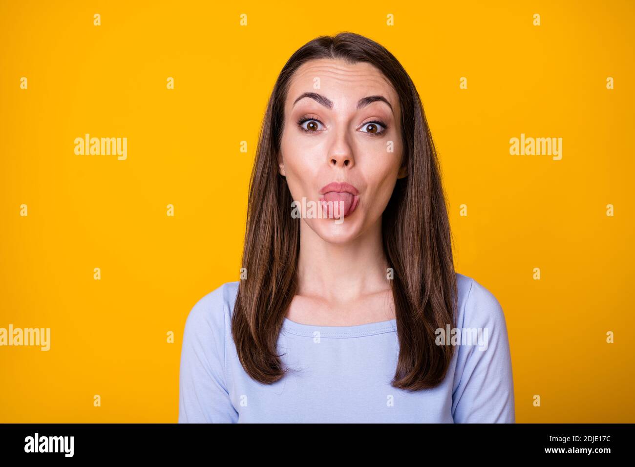 Closeup photo of attractive pretty lady good mood sticking tongue out mouth teasing boyfriend fooling around childish wear casual shirt isolated Stock Photo