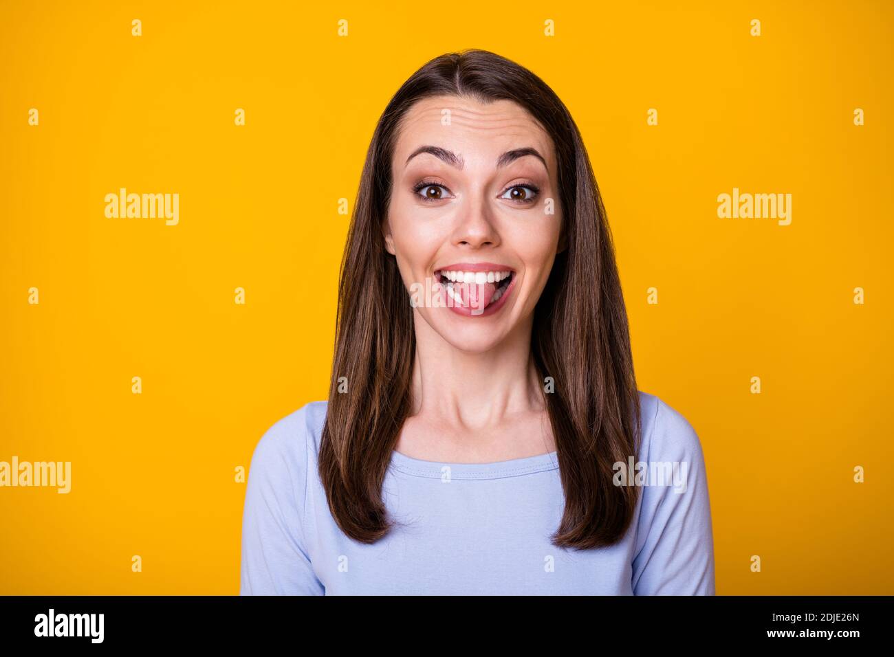 Closeup photo of attractive pretty cheerful lady good mood sticking tongue out mouth teasing boyfriend fooling around wear casual shirt isolated Stock Photo