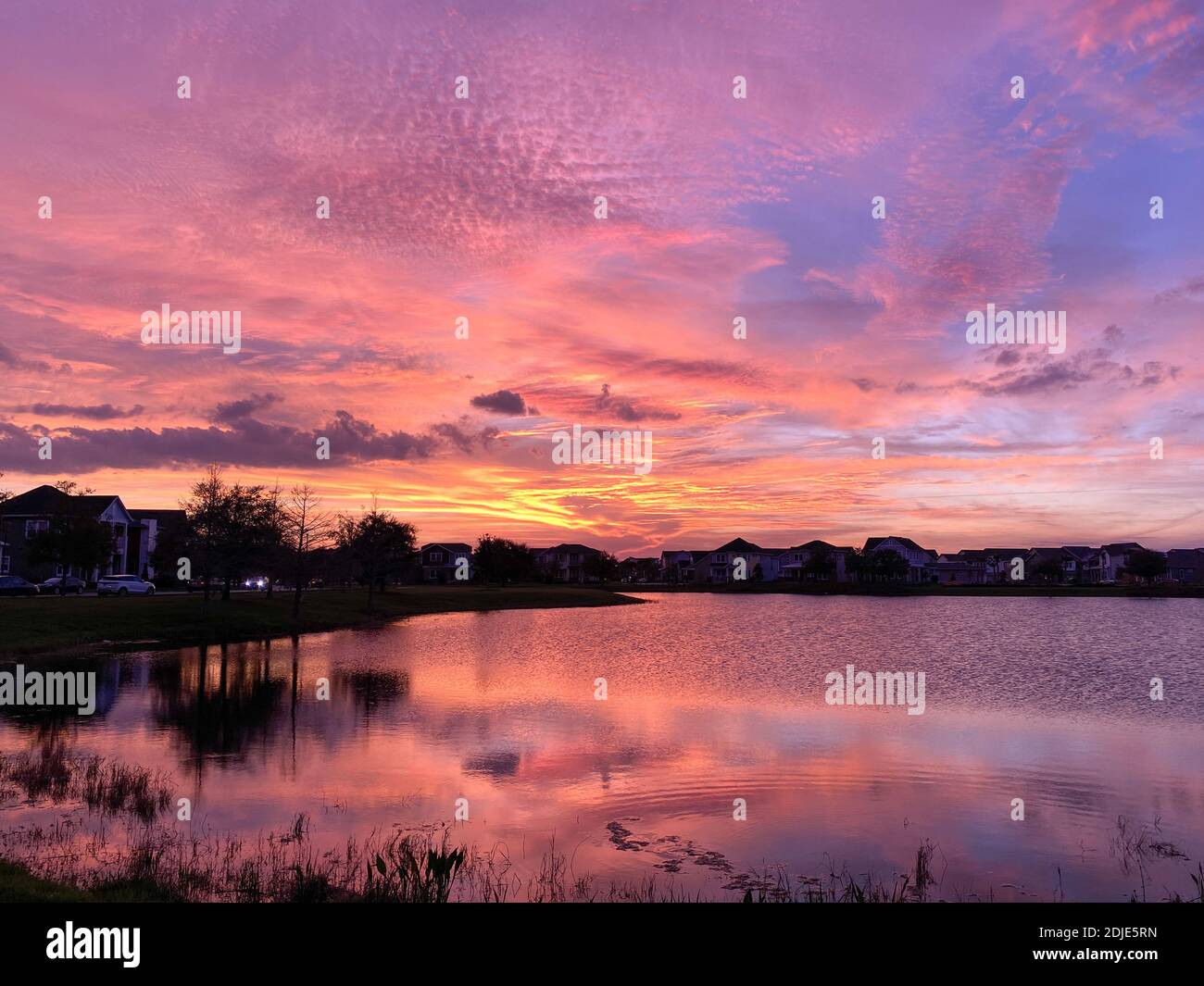 Beautiful pink, orange and blue sunset reflecting on a lake in a ...