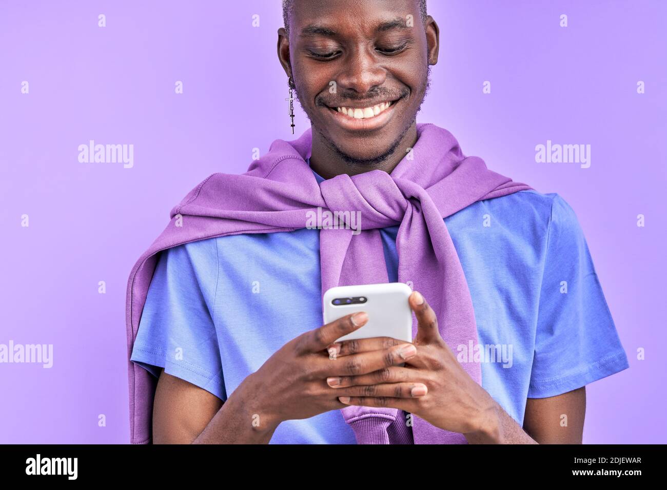 african guy looking at smartphone, wathcing funny video or talking with someone. isolated on purple background Stock Photo - Alamy african guy looking at smartphone, wathcing funny video or talking with someone. isolated on purple background Stock Photo - Alamy