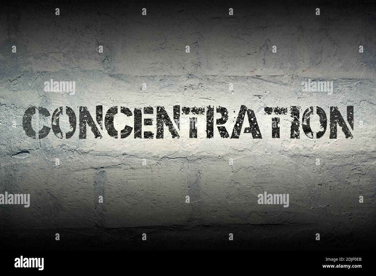 concentration stencil print on the grunge white brick wall Stock Photo