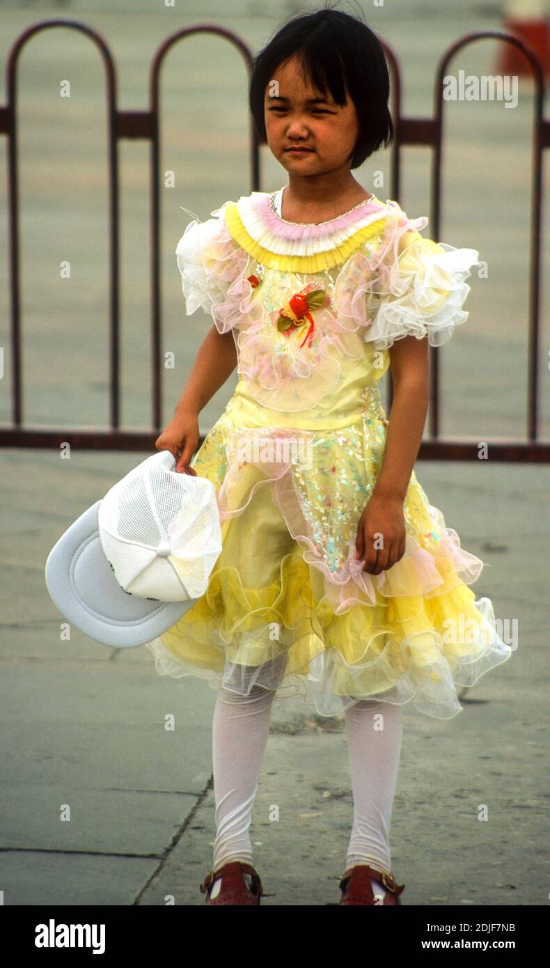 Young girl in pretty frilly dress Tiananmen Square Beijing