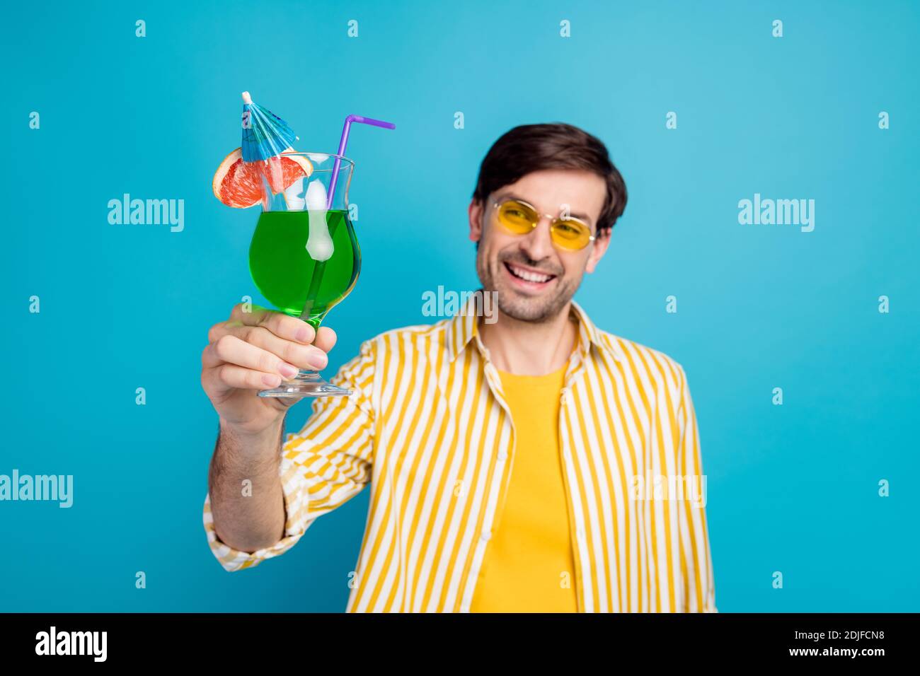 https://c8.alamy.com/comp/2DJFCN8/blurred-photo-of-positive-cheerful-man-tourist-enjoy-resort-chilling-look-hold-alcohol-cocktail-wear-white-clothes-isolated-over-blue-color-background-2DJFCN8.jpg