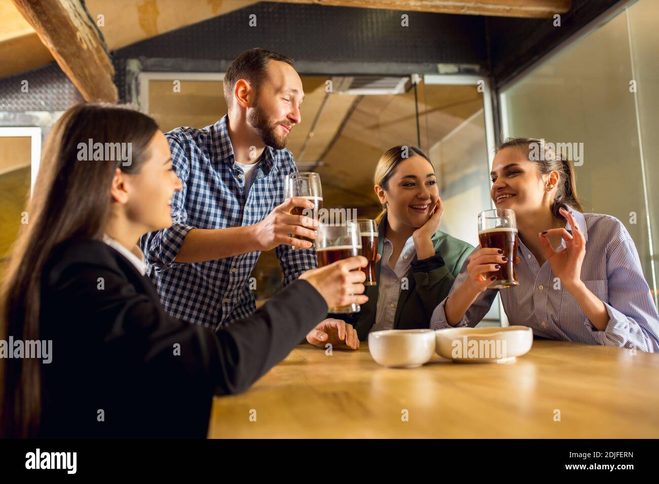 Laughting. Happy coworkers celebrating corporate event after tensioned