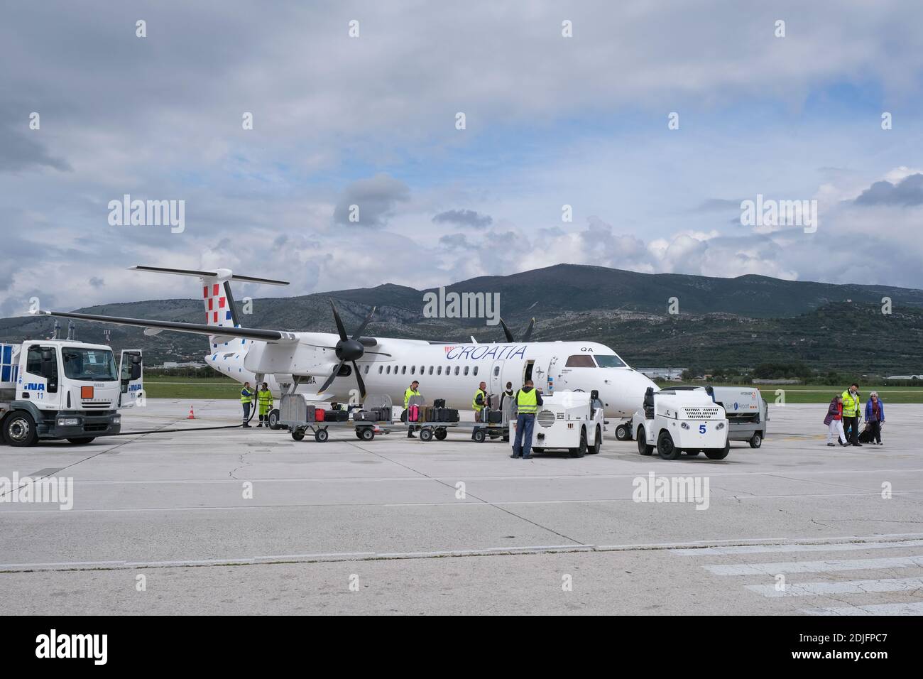 Croatia Airlines Bombardier Q400 parked on a runway  during disembarkation at Split airport, Dalmatia, Croatia, Europe. Stock Photo