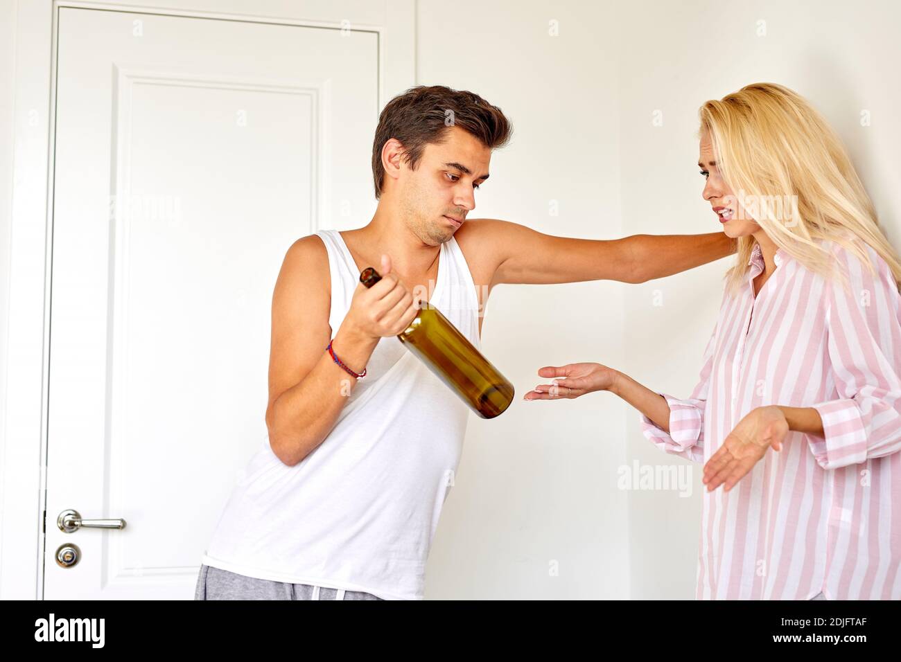 battered-young-woman-looks-depressed-as-alcohol-addict-man-punish-her