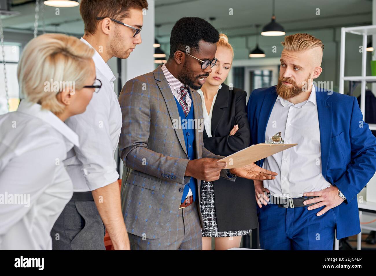 side view on confident afro american leader of team talking with employees, asking to hurry up for deadline Stock Photo