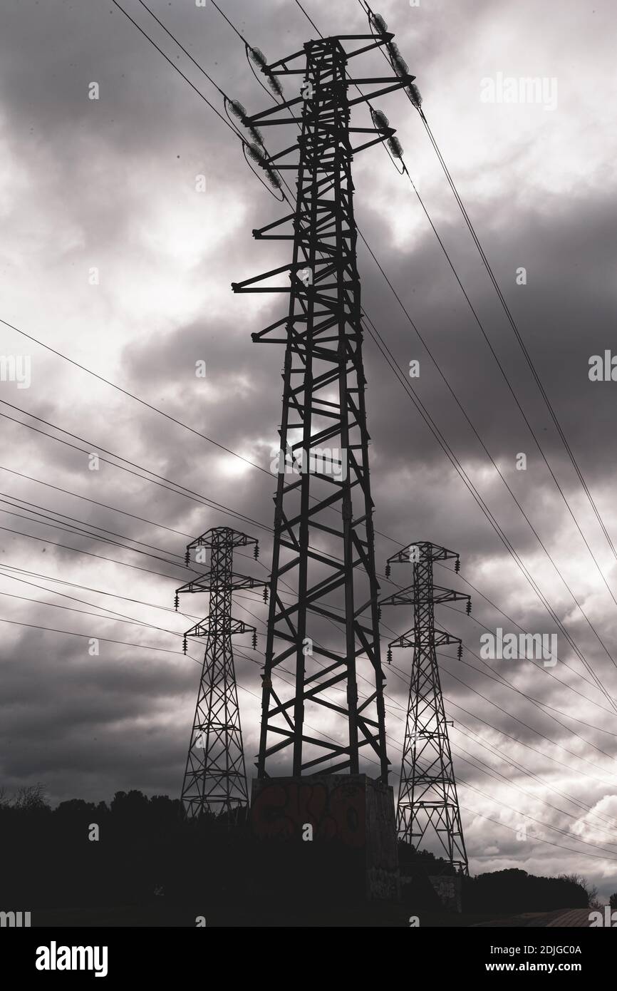 high voltage towers with cloudy sky Stock Photo - Alamy