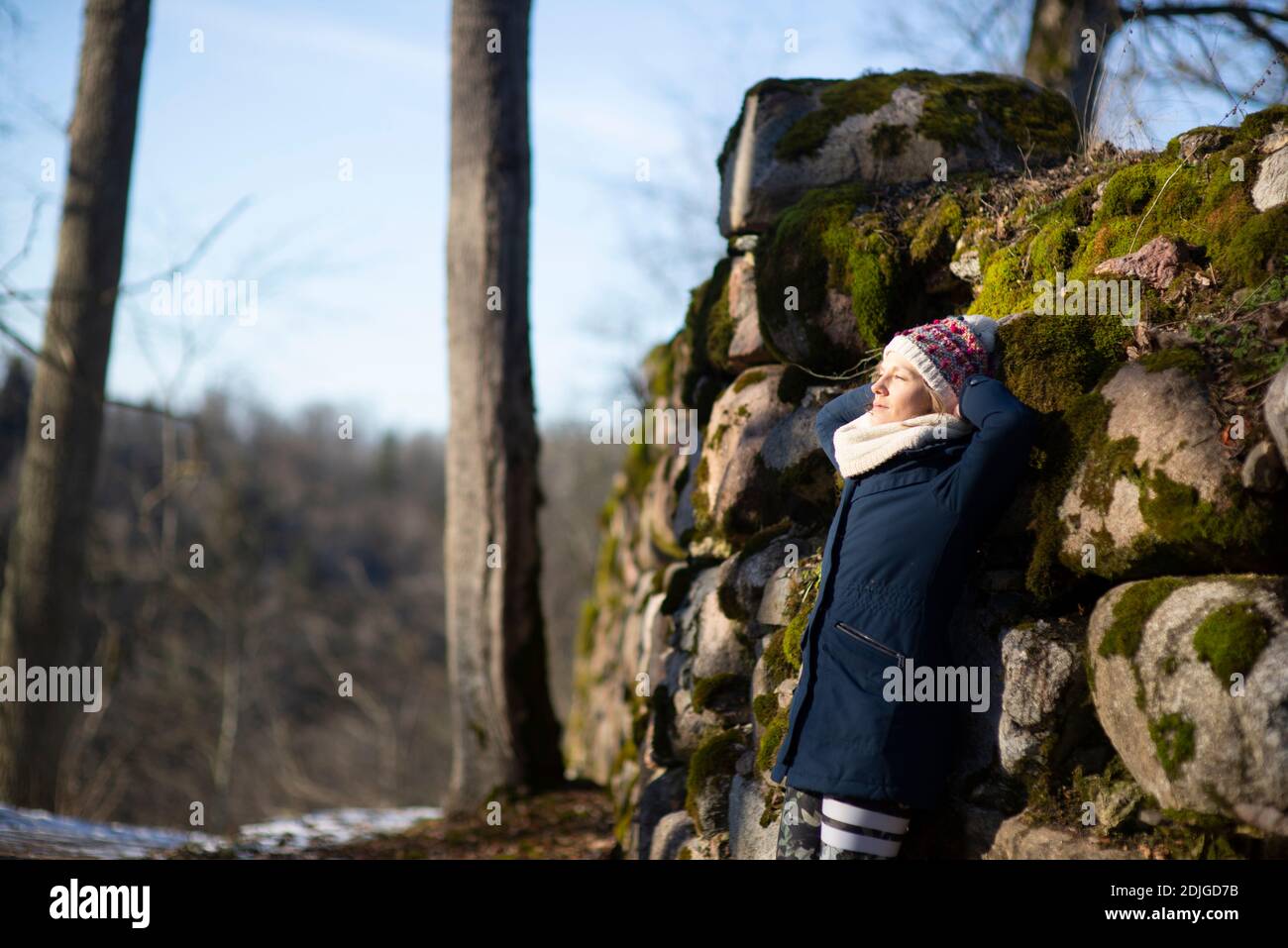 Woman leaning on rocks hi-res stock photography and images - Alamy