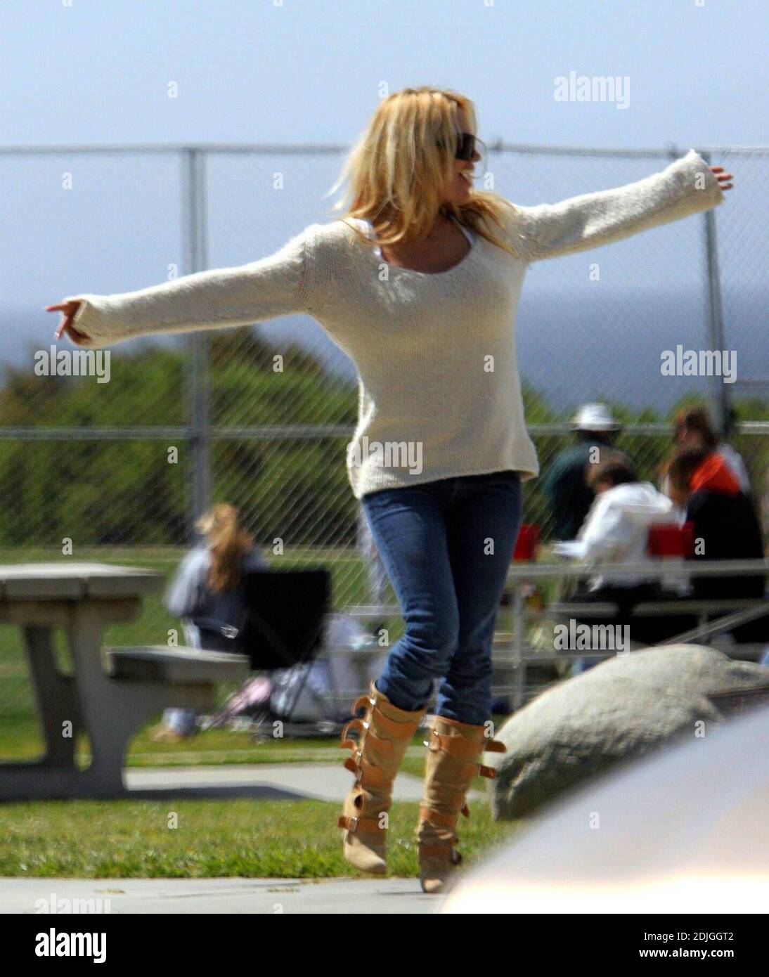 Exclusive!! Pamela Anderson appears to have an aching back. The ex Baywatch beauty known for her ample assets,  was stretching as she waited for her sons to finish playing sports in Malibu, Ca. 03/18/06 Stock Photo