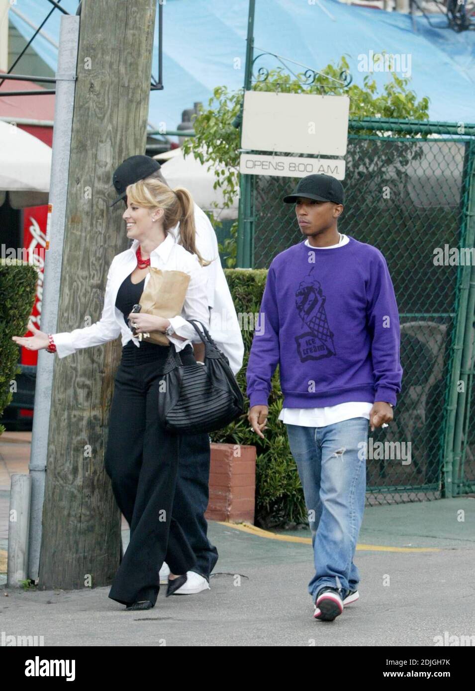 Exclusive!! Pharrell Williams has  lunch with a female friend before being driven off by his bodyguard in his signature grey two tone Roll Royce, Miami Beach, FL, 1/27/06 Stock Photo