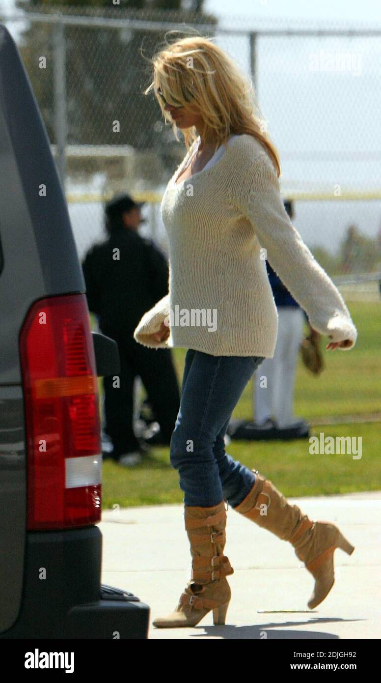 Exclusive!! Pamela Anderson appears to have an aching back. The ex Baywatch beauty known for her ample assets,  was stretching as she waited for her sons to finish playing sports in Malibu, Ca. 03/18/06 Stock Photo