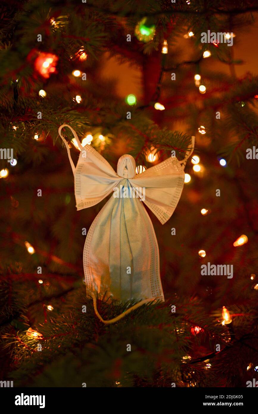 Two surgical masks formed into the crafty shape of an angel with wings ...
