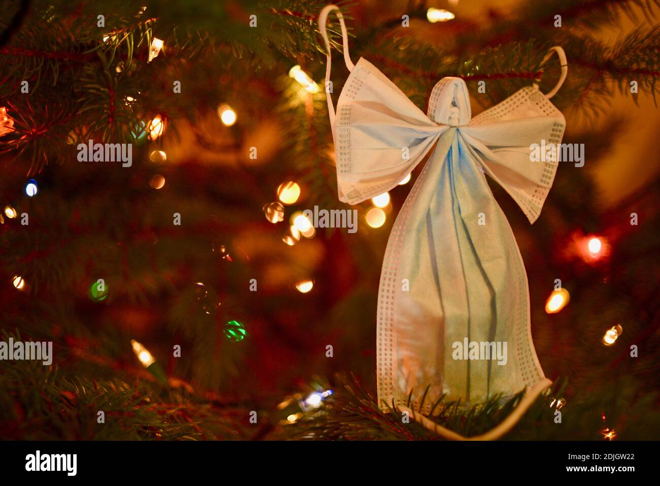 Two surgical masks formed into the crafty shape of an angel with wings ...