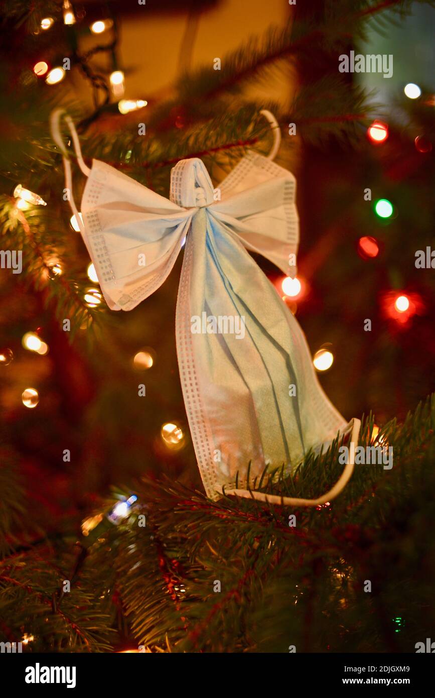 Two surgical masks formed into the crafty shape of an angel with wings ...