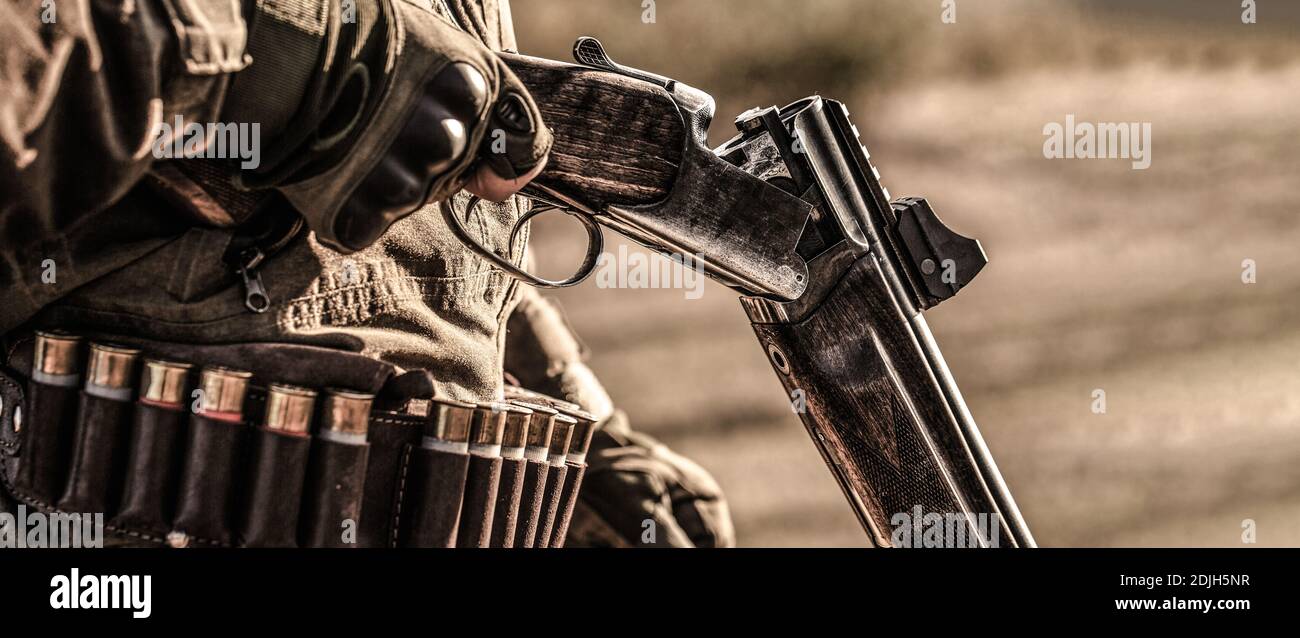 Hunter man. Hunting period. Male with a gun, rifle. Man is charging a ...
