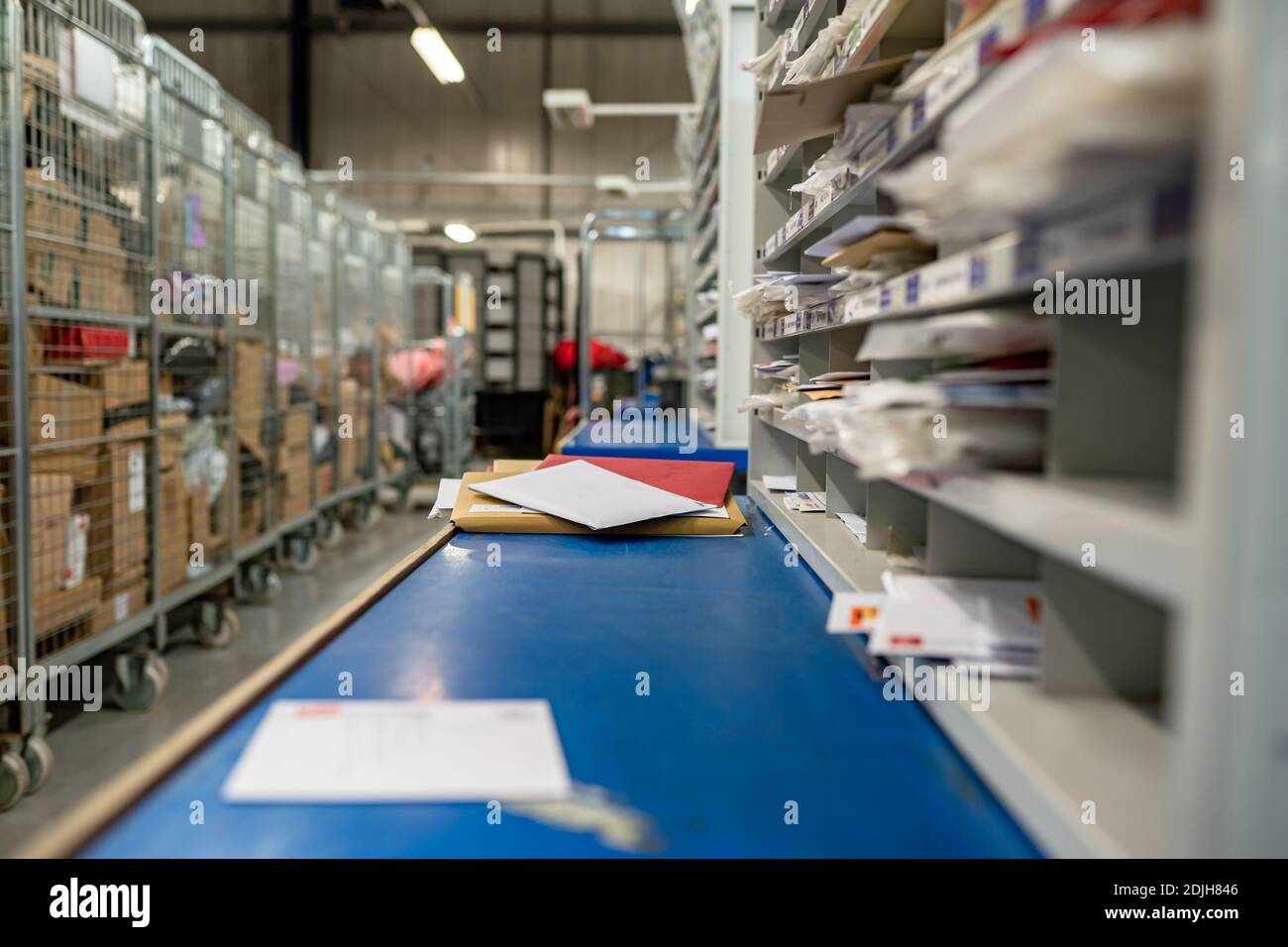 Letters on a sorting frame, table and shelves in a mail delivery sorting centre. Postal service, post office inside Stock Photo