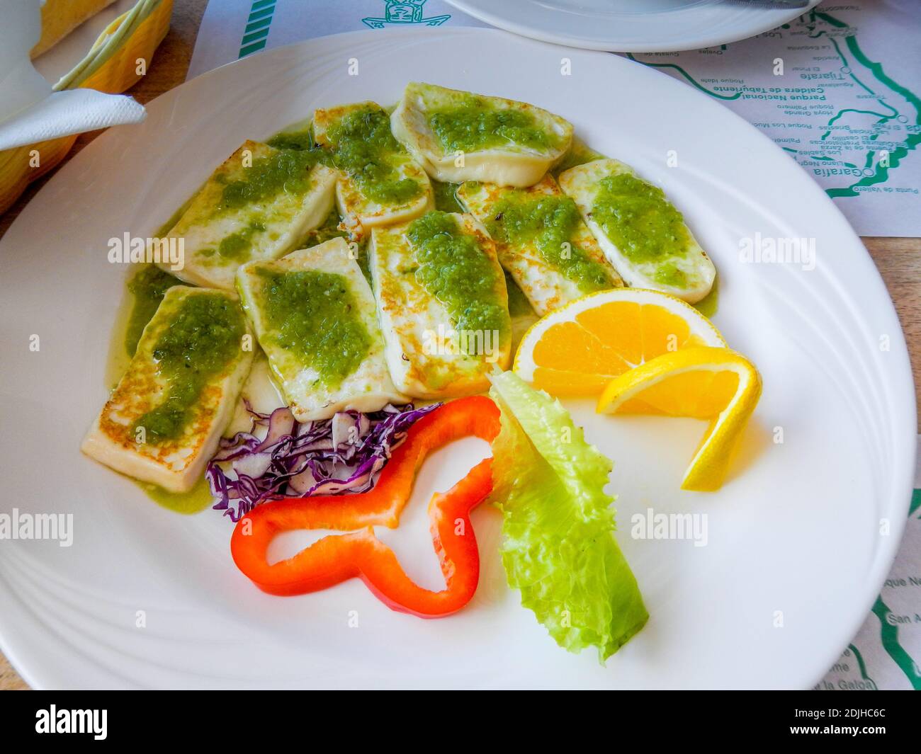 Traditional Tapas plate with Roast cheese with green mojo. High quality photo Stock Photo