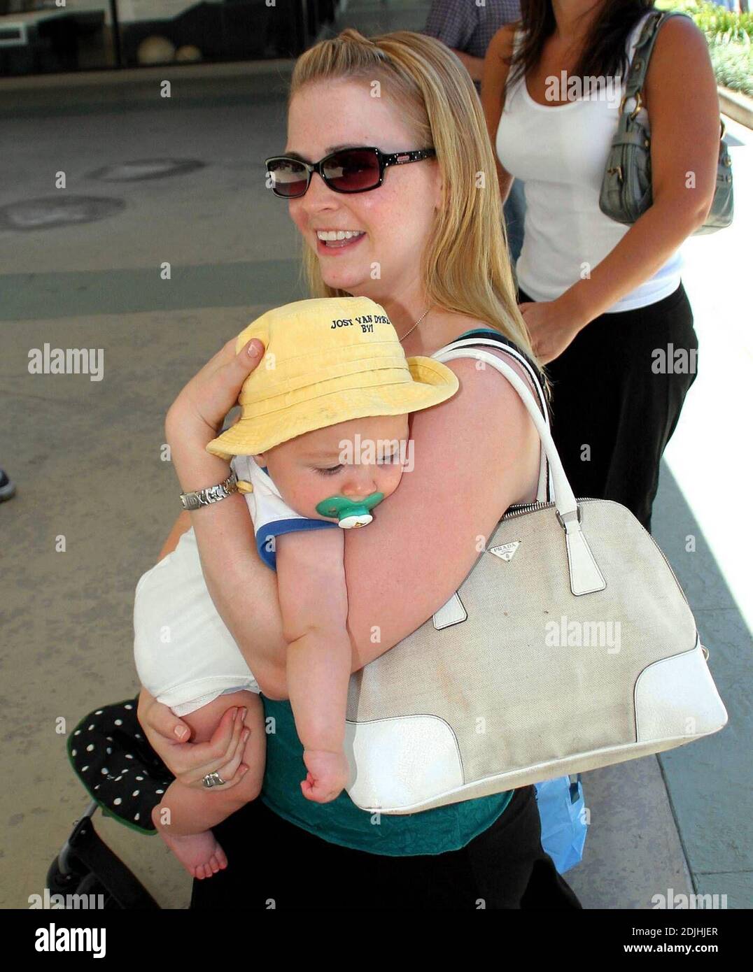 Actress Melissa Joan Hart, best known as the TV star of "Sabrina the Teenage Witch," went shopping with baby son at Kitson and Kitson Kids in LA with a friend. After shopping they retired to the News Cafe to escape the heat. 6/16/06 Stock Photo