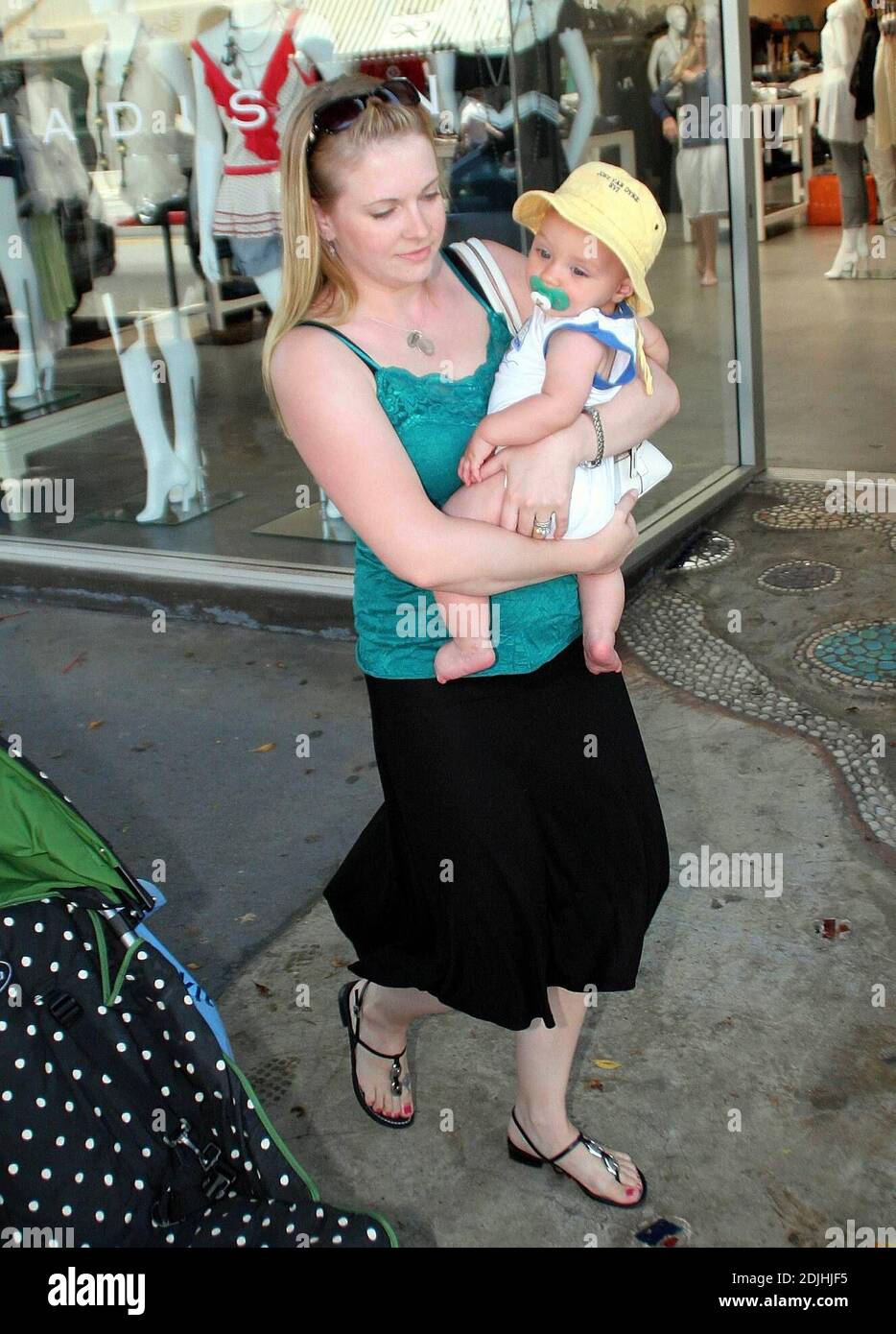 Actress Melissa Joan Hart, best known as the TV star of 'Sabrina the Teenage Witch,' went shopping with baby son at Kitson and Kitson Kids in LA with a friend. After shopping they retired to the News Cafe to escape the heat. 6/16/06 Stock Photo