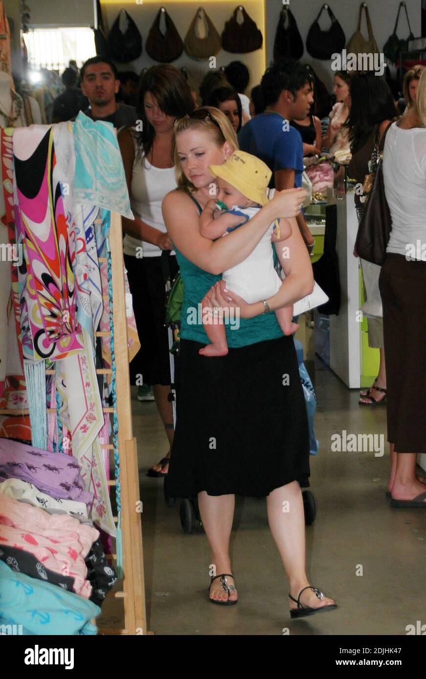Actress Melissa Joan Hart, best known as the TV star of 'Sabrina the Teenage Witch,' went shopping with baby son at Kitson and Kitson Kids in LA with a friend. After shopping they retired to the News Cafe to escape the heat. 6/16/06 Stock Photo