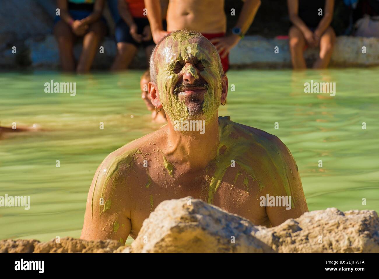 A tourist in his mid-50s enjoys the green sulphur- rich waters in the ...